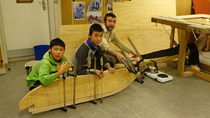 Figure 1. Bending the wood (from the left: Gr 7 pupils Ajaattoq Kristiansen, Sivert Kristiansen and teacher Max Audibert). Photo courtesy of Kamilla Oliver.