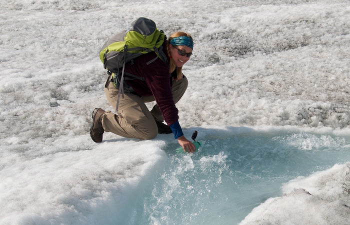 Teacher Tina Ciarametaro fills up her water bottle with freshly melted glacial water. Sukkertoppen Ice Cap, Greenland. Photo by Tina Ciarametaro (PolarTREC 2014), courtesy of ARCUS.